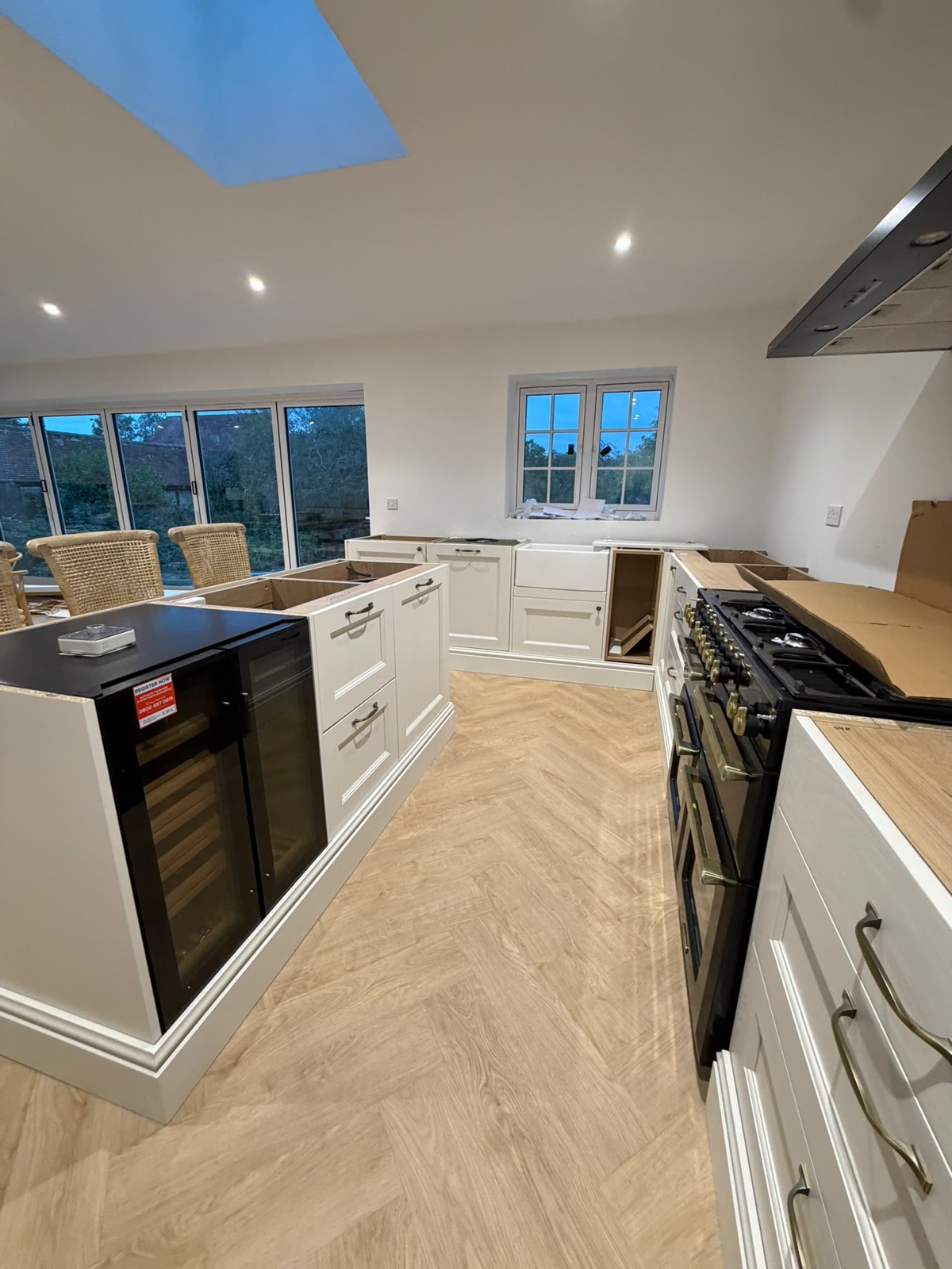Open-plan kitchen with downlights and a wine cooler island