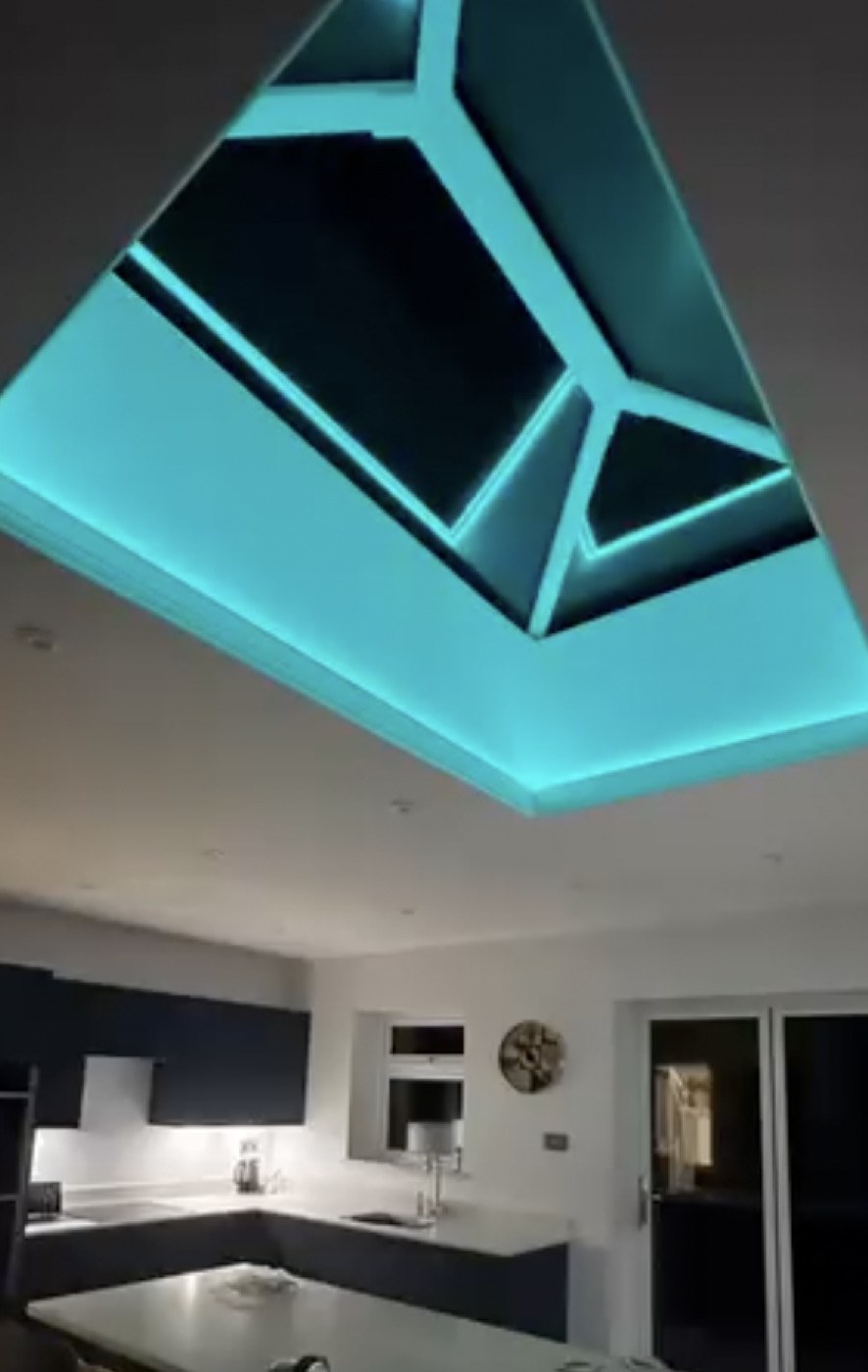 Colour-change lantern-roof feature lighting in a kitchen